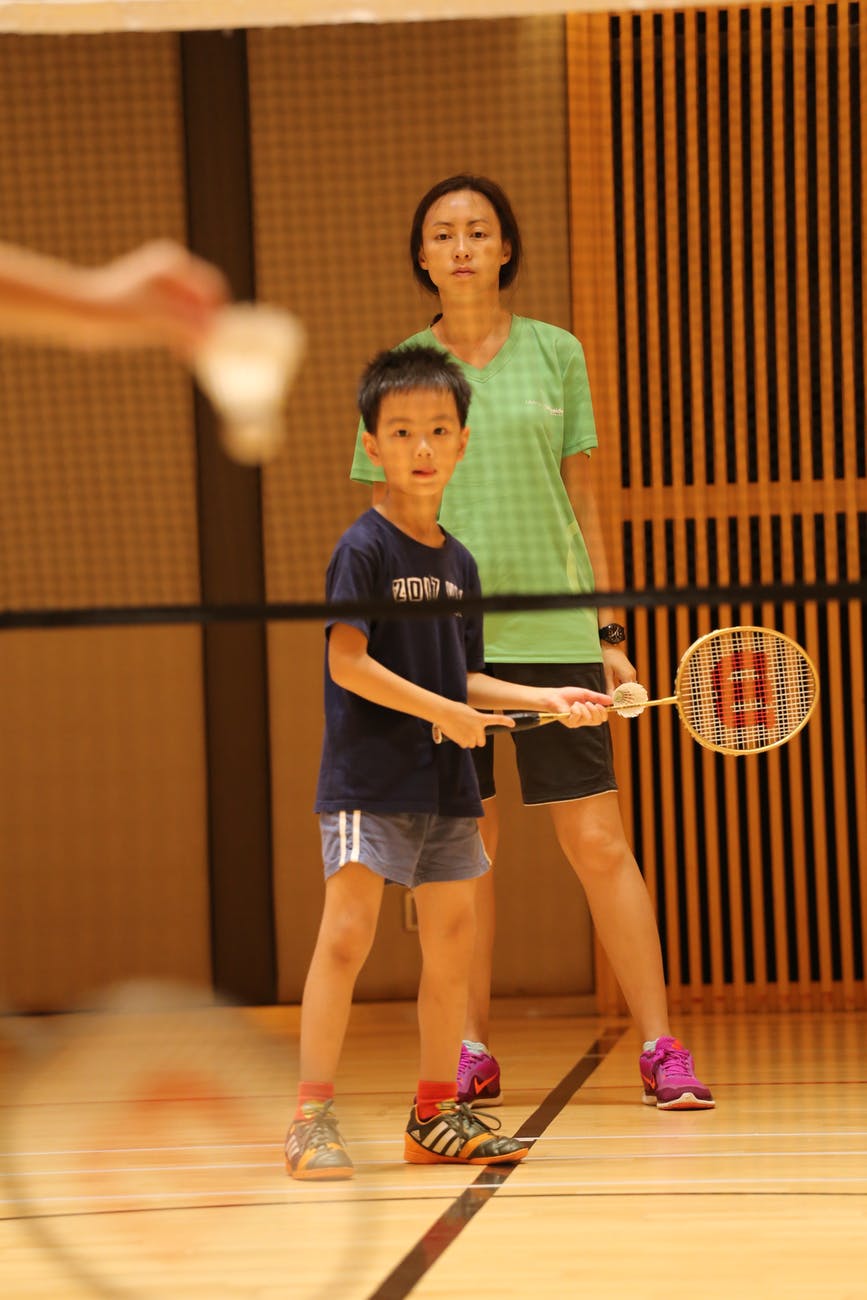 a boy playing badminton