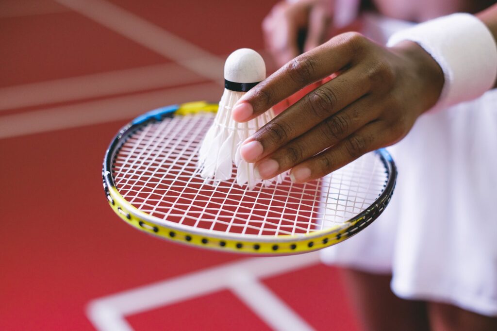 close up shot of a shuttlecock on a badminton racket