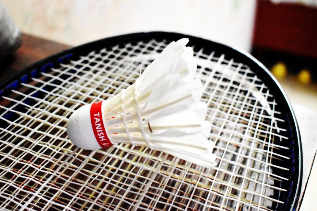 close up shot of a shuttlecock on a racket